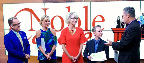 Noble McInyre giving A Noble Cause award on TV segment