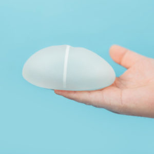 Someone holding a silicone breast implant
