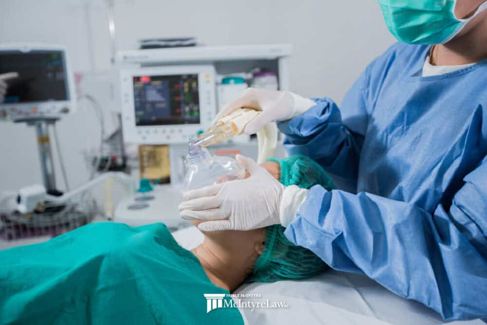 Patient being put under anesthesia in a medical setting.