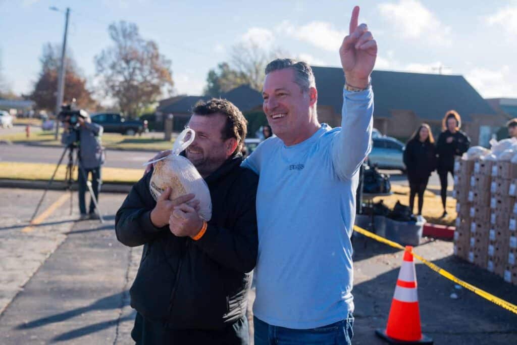 A photo of Noble McIntyre giving out turkeys on the 16th Annual Day of Kindness.