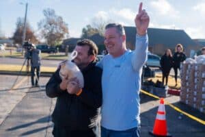 A photo of Noble McIntyre giving out turkeys on the 16th Annual Day of Kindness.